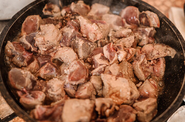 Fried veal liver in a pan. Braised cow and pork liver