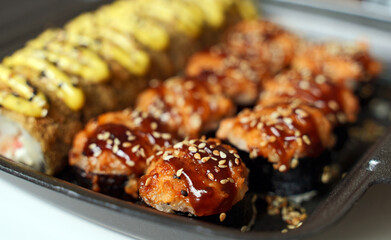 Box with tasty sushi rolls. Home food delivery.