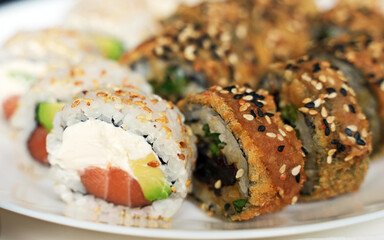 Plate with tasty sushi rolls. Home food delivery.