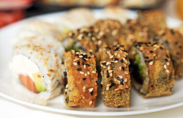 Plate with tasty sushi rolls. Home food delivery.