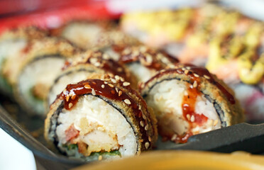 Box with tasty sushi rolls. Home food delivery.