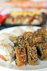 Plate with tasty sushi rolls. Home food delivery.