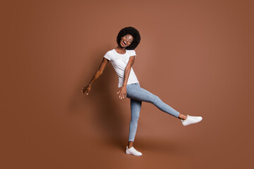 Full length body size photo of dancing woman laughing at party overjoyed isolated on brown color background