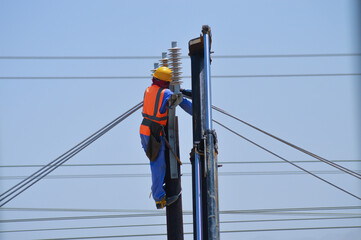 Worker Installing Electric Poles