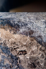 Dirty and rusty metal surface. Close-up of a part of a faucet in soft focus at high magnification.
