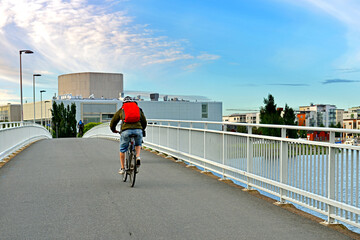 Cyclists on bridge across river Oulujoki. Oulu, Suomi