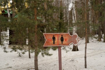 a sign indicating the direction to the men's and women's toilets