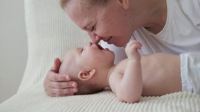 4k. happy mothers face kiss play with little baby. Face to Face
