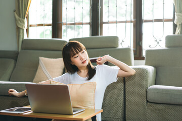 Young adult asian student woman learning at home indoor on day.