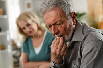 Old man taking pills. Senior drinking medicine.