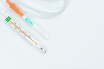 Dropper with mercury thermometer on white background. Concept of treatment and health.