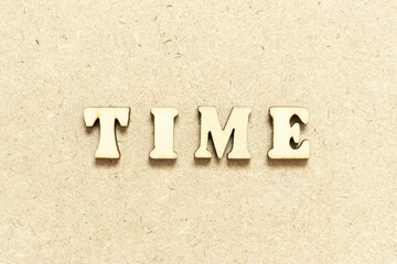 Alphabet letter in word time on wood background