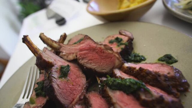 fine dining plate of lamb chops with wide angle pull back movement