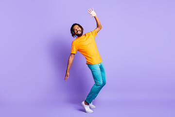 Full size photo of optimistic nice brunet man wear yellow t-shirt isolated on purple color background