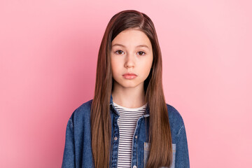 Photo portrait of serious schoolgirl wearing jeans jacket isolated on pastel pink color background