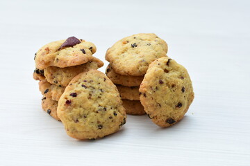 Shortbread cookie and chocolate chips on white wooden background
