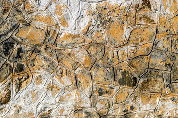 The background old gray stony wall