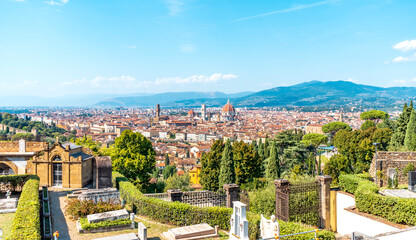 Fototapeta premium Scenic view of Florence from the Basilica of San Miniato al Monte, near Piazzale Michelangelo. Blue sky and vegetation; Tuscany region, Italy.
