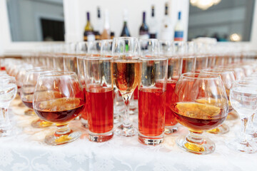 Table setting for a holiday or party. Glasses for spirits, champagne and juice. Whiskey-Cola drink. Close-up. Russia, Saint Petersburg, 04.04.2021
