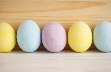 Colorful Easter eggs on a wooden background, close-up.