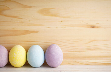 Colorful background of easter eggs on wooden background, place for text