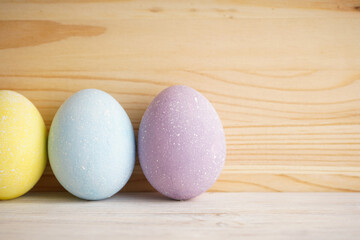 Colorful background of easter eggs on wooden background, close-up