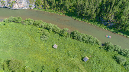 AERIAL: catamaran rafting on a beautiful mountain river in summer. a hike with overcoming obstacles in a high-altitude forest on rafting