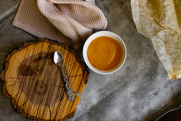 Natural honey herbs, the may. A healthy and nutritious elixir with a sticky consistency in a round bowl on a wooden stand