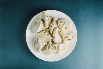 Georgian Khinkali on a blue background. Georgian dumpling top view