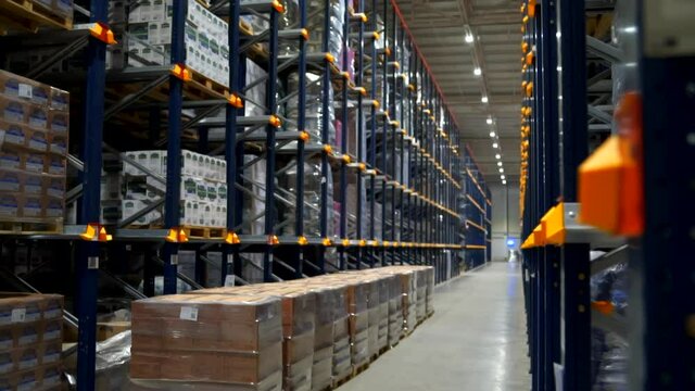 View on the endless industry racks with a food product boxes folded at factory storage of transport department
