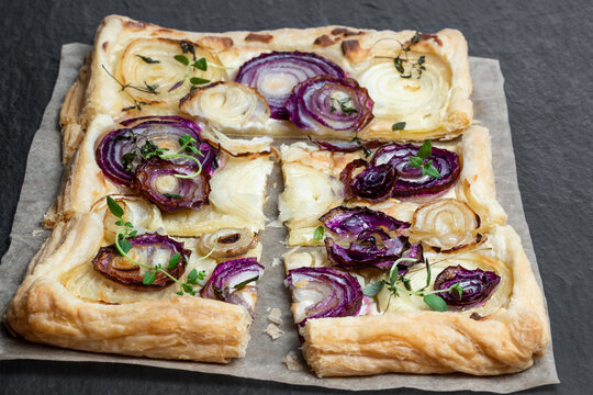 French Onion Tart On Black Stone Background