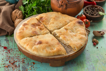 homemade round meat pie with potato on the table