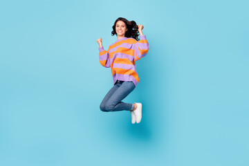 Fototapeta na wymiar Full length body size view of lovely lucky cheerful wavy-haired girl jumping rejoicing having fun isolated over bright blue color background