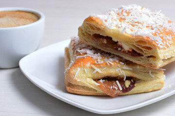 Arequipe puff pastry displayed on white wooden background