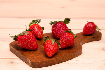 berries strawberries on a wooden board close-up on a light background