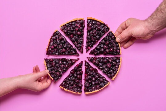 Blueberry pie top view isolated on purple background. Hands grabbing slices of pie.