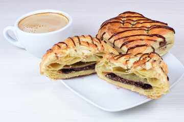 Chocolate puff pastry displayed on white wooden background