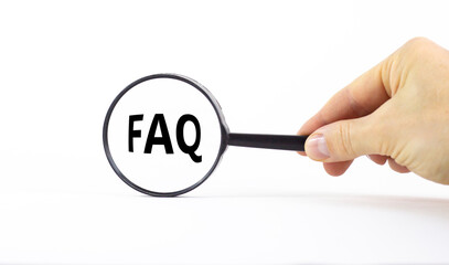 FAQ, frequently asked questions symbol. Magnifying glass with word 'FAQS, frequently asked questions' on beautiful white background. Business, frequently asked questions concept, copy space.