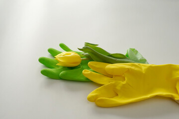 Green and yellow rubber glove and yellow tulip