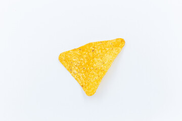 Corn chips into a glass bowl, nachos isolated on white background with copy space 