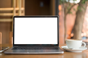 Mockup of laptop computer with empty screen with coffee cup and smartphone on table of the coffee shop background,White screen