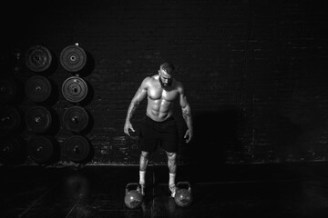 Young active sweaty strong muscular fit man with big muscles preparing and concentrating for heavy...