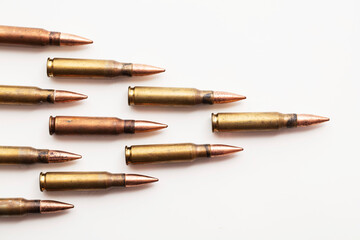 A group of bullet ammunition shells on a white background - obrazy, fototapety, plakaty