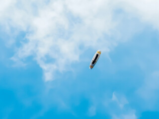 paraglider from below in a bright blue sky