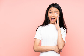 Teenager Chinese woman isolated on pink background with surprise and shocked facial expression