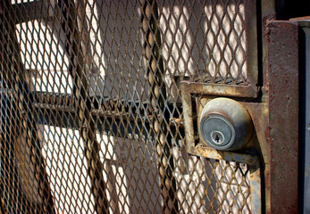 Old rusted security gate with lock
