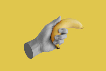 Hand holding banana, isolated on yellow background