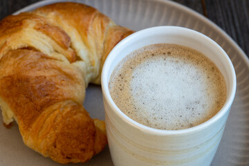 plate with croissant and milk coffee