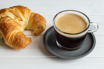 cup of black coffee and croissant