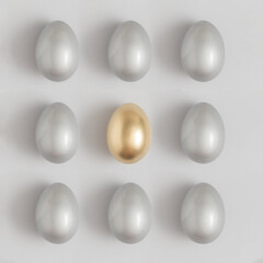 Pattern made of silver and gold easter egg on a gray background. Minimal holiday concept. Flat lay, top view.